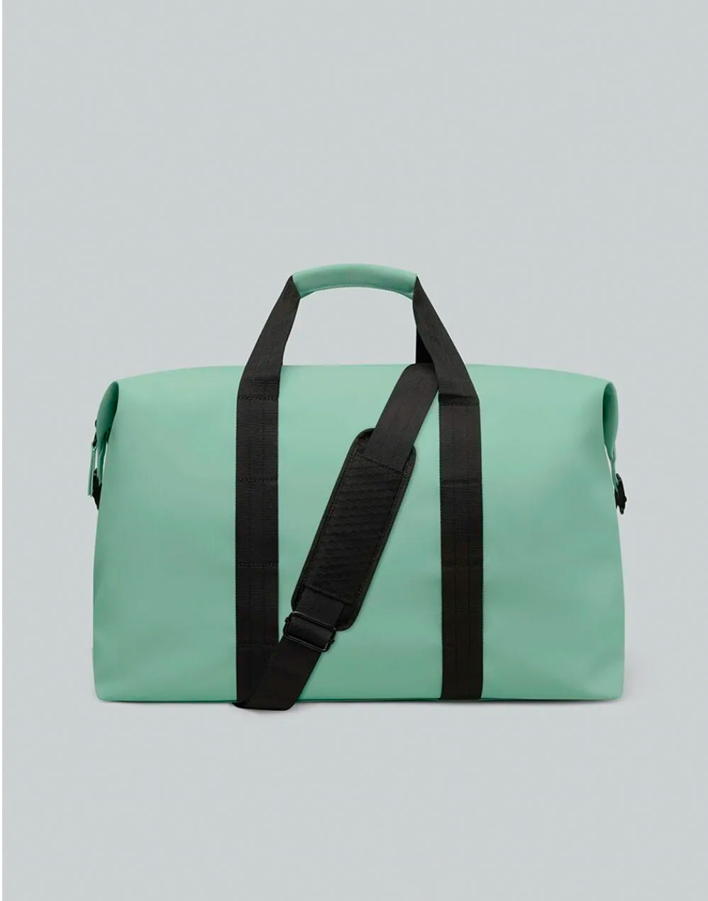 Vista frontal del bolso Däsh color menta, con asas negras y correa de hombro con almohadilla.